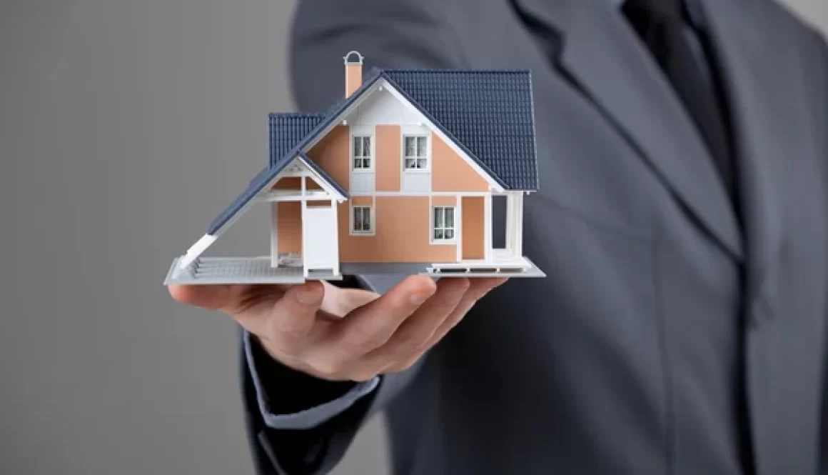 depositphotos_23287032-stock-photo-real-estate-agent-with-house